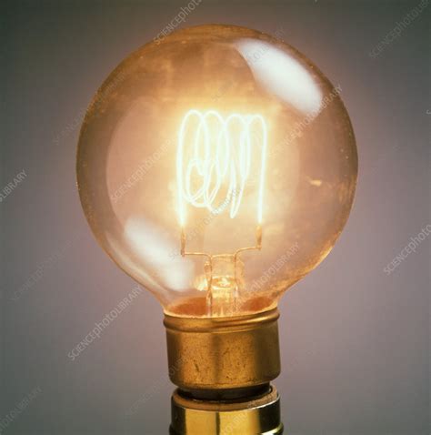 Lit light bulb showing the glowing filament - Stock Image - T194/0391 ...