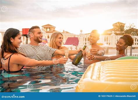 Happy Friends Toasting Champagne At Pool Party Young People Having