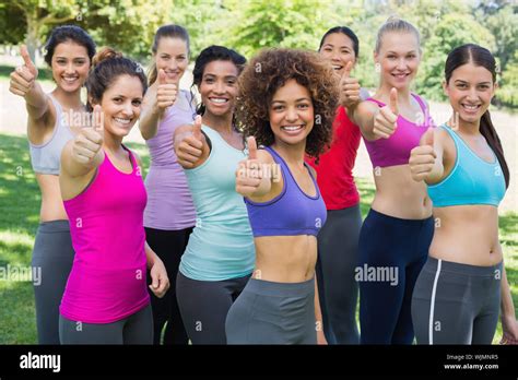 Portrait Of Successful Sporty Women Gesturing Thumbs Up In Park Stock Photo Alamy