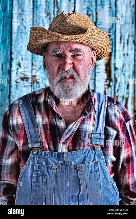 Elderly Man In Bib Overalls Post Processed For Added Drama Stock Photo