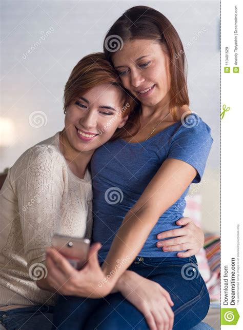 Homosexual Couple Of Lesbian Women At Home On The Couch Watching Stock Image Image Of Partner