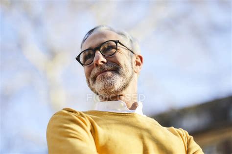 Portrait Of Confident Mature Man Outdoors Copy Space Yellow Stock Photo