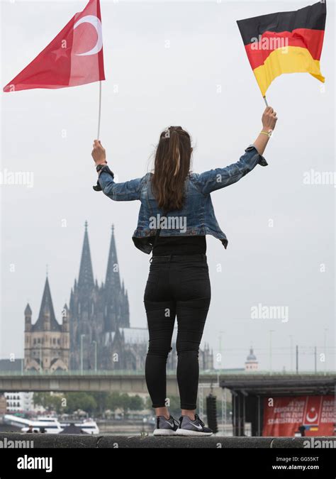 Woman Holding A German And Turkish Flag With Cologne Cathedral K Lner