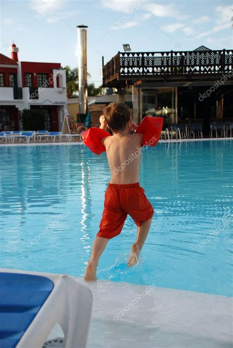 Boy Jumping Into The Swimming Pool — Stock Photo © Mariacarlson 9298864