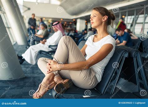 Pretty Young Woman Waiting At A Gate Area Of A Modern Airport Stock