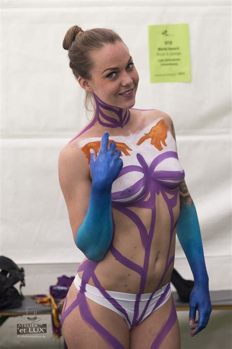 A Woman With Painted Body And Hands On Her Chest