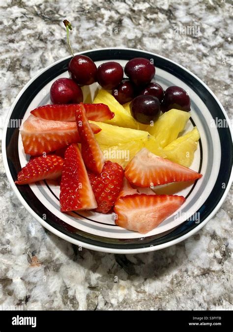 Strawberries Pineapples And Cherries In A Bowl Stock Photo Alamy