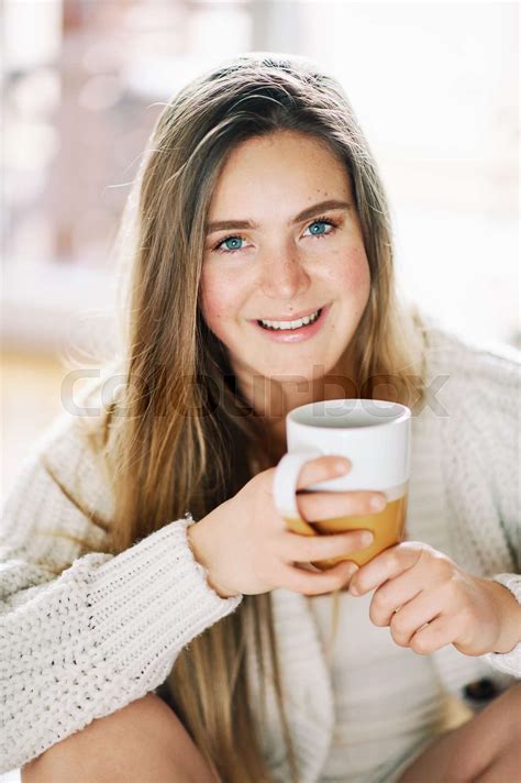 Portrait Of Young Pretty 20 Year Old Girl Relaxing At Home With Cup Of