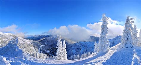 White clouds mountains frost blue sky panorama cold forest trees road ...