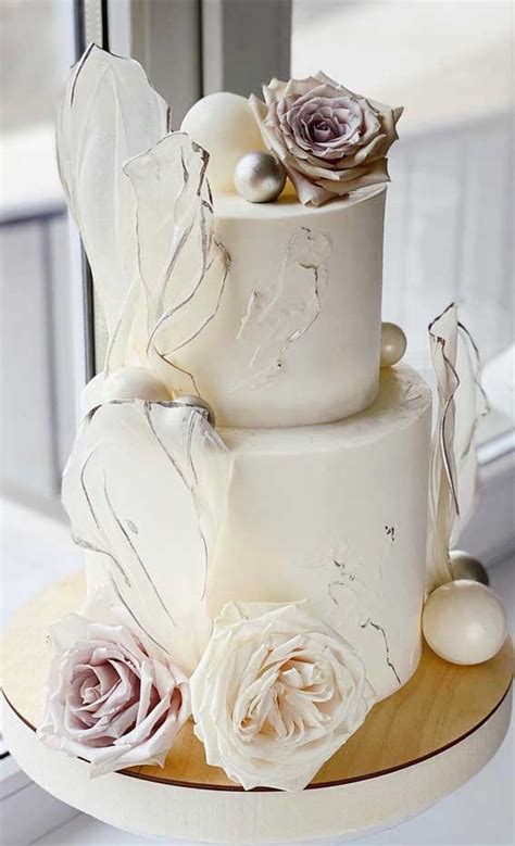 40 pretty and new wedding cake trends 2021 white contemporary cake with wafer papers