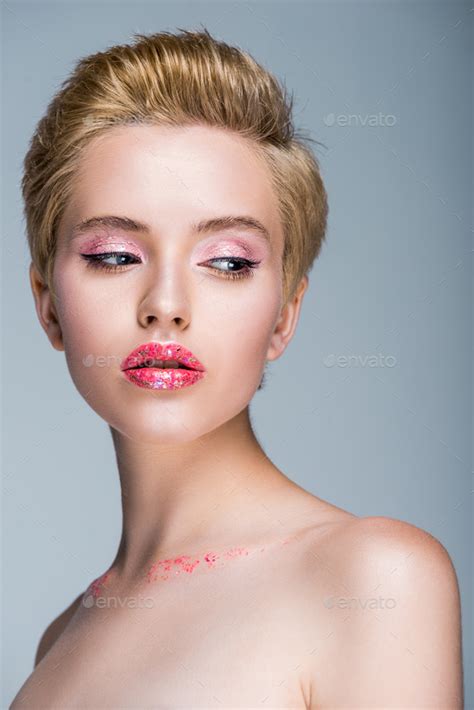 Attractive Naked Woman With Glitter On Face And Body Looking Away Isolated On Grey Stock Photo