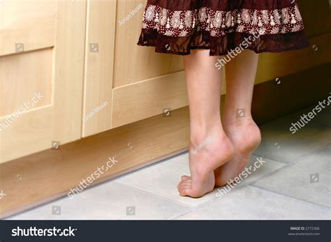 Conceptual Image Of A Pair Of Young Feet On Tip Toes
