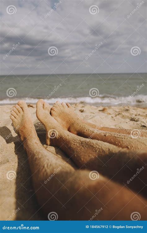 couple legs in sand close up on sunny beach couple in love relaxing together on sandy seashore