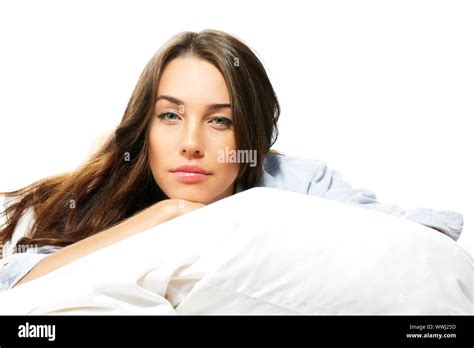 Portrait Of A Beautiful Woman In Bed On White Background Stock Photo