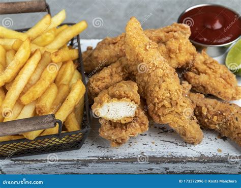 Crispy Fried Breaded Chicken Breast Strips French Fries And Sauce Stock