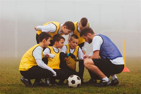 Coach Giving Instruction To His Kids Soccer Team Stock Photo Download