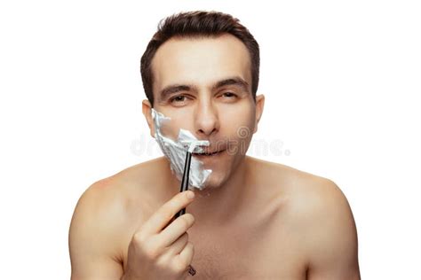 Portrait Of Man With Half Face Covered With Shaving Cream Shaving With