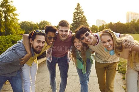 Group Of Cheerful Young Diverse Friends Meeting In Summer Park And