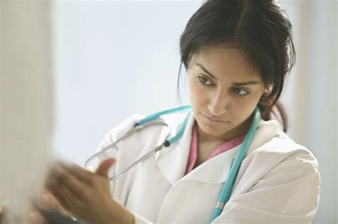 Female Doctor Examining A Patient Asuragen Asuragen