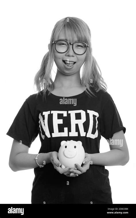 Young Happy Asian Nerd Woman Smiling And Holding Piggy Bank Stock Photo