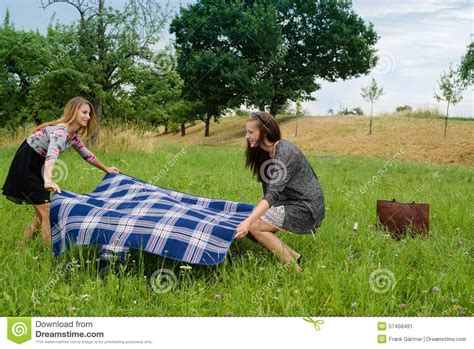 Two Girls Spreading A Blanket For Picnic Stock Image Image Of Holiday