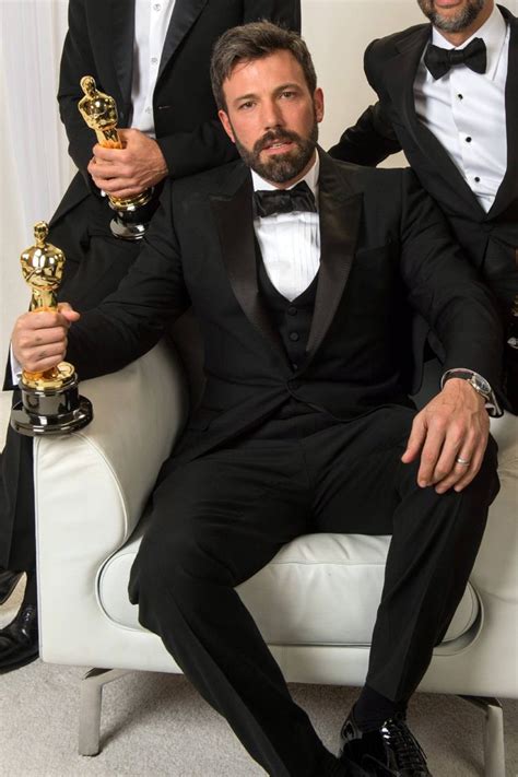Three Men In Tuxedos Posing For A Photo With Their Oscars Trophies And