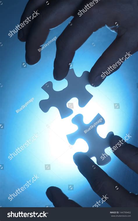 Hands Trying Fit Two Puzzle Pieces Stock Photo 144799402 Shutterstock