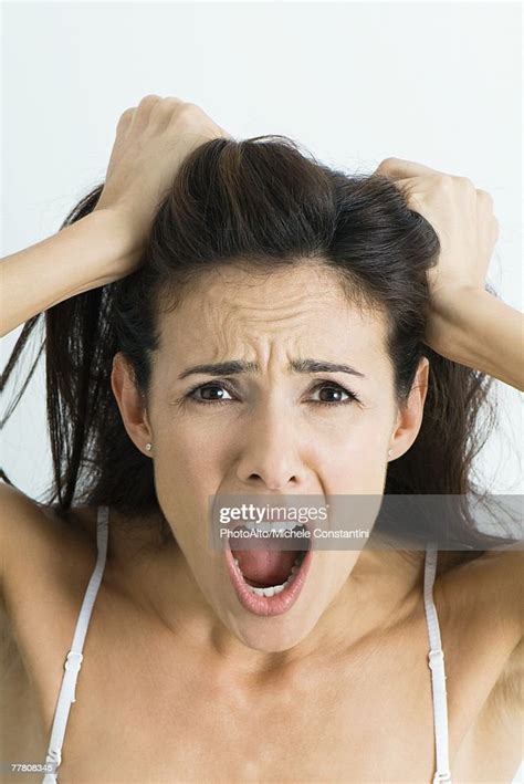 Woman Pulling Hair And Screaming At Camera Portrait High Res Stock