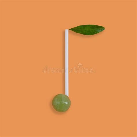 Vertical Shot Of A Green Candy With A White Stick And A Green Leaf On