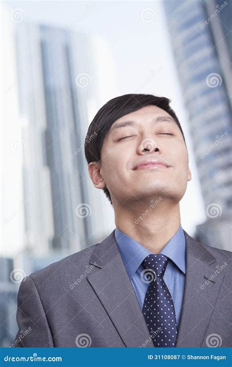 Young Businessman With Eyes Closed And Head Back Smiling Portrait