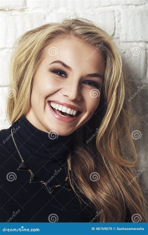 Portrait Of Happy Cheerful Smiling Young Beautiful Blond Woman Stock
