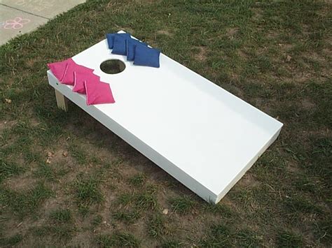Take turns tossing your bean bags at the opposite target board! Cornhole Toss Contest|Odds On Blog