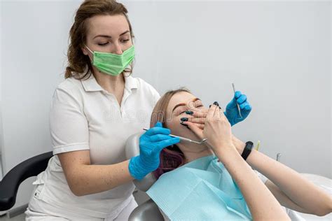 Female Patient Sits At Dentist And Closes Her Mouth From Female Dentist Because She Is Afraid