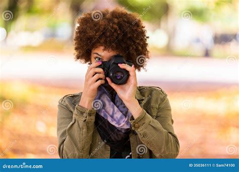 Autumn Outdoor Portrait Of Beautiful African American Young Woman Holding A Digital Camera