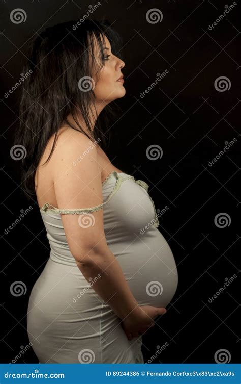 Maternity Beautiful Pregnant Brunette In Light Clothes Showing Stock Photo Image Of Fashion