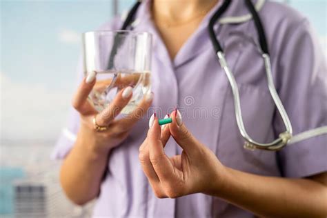 Cropped Photo Of Female Doctor Holding Pill And Glass Of Water In Two
