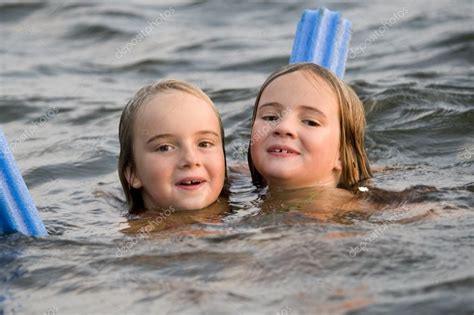 Young Girls Swimming In Lake — Stock Photo © Designpicsinc 31791527