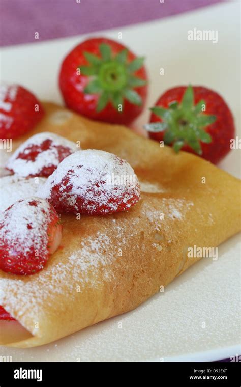 Crepe With Strawberries Dusted With Icing Sugar Stock Photo Alamy