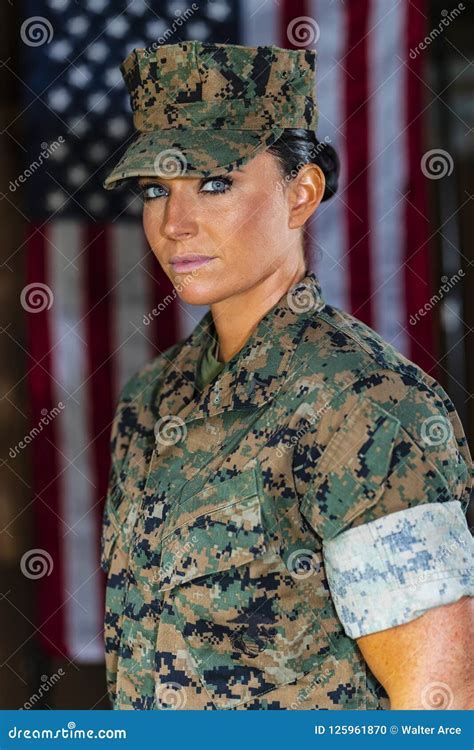 A United States Female Marine Posing In A Military Uniform Stock Photo