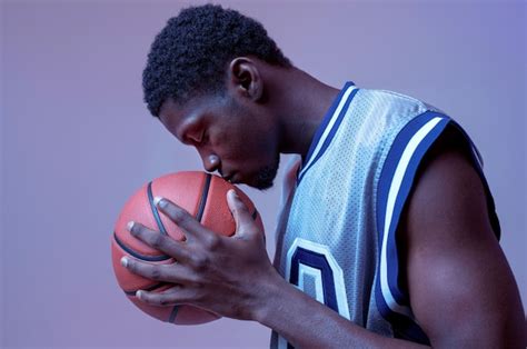 Premium Photo Serious Basketball Player Poses With Ball Professional