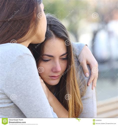 Sad Girl Crying And A Friend Comforting Her Stock Photo