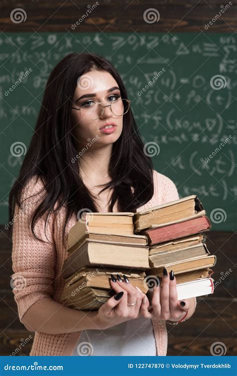 Beautiful Brunette Girl Holding Heap Of Books In Her Hands Smart