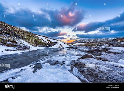 A Cold Snowy River In The Highlands Of Iceland Framed By Pastel Skies