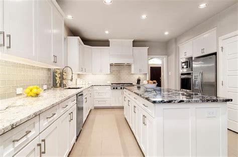 Not only in the kitchen cabinet set area, if you can use the refrigerator it is also grey in color so that it creates unity. White Kitchen with Gray Glass Backsplash and Granite ...