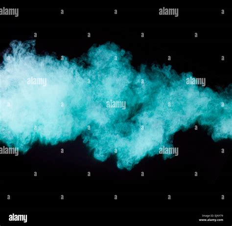 Freeze Motion Of Blue Dust Explosion Isolated On Black Background Stock