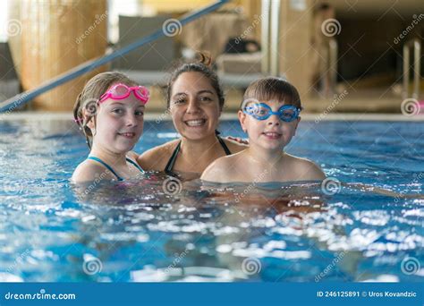Family having fun in pool stock image. Image of expressive - 246125891