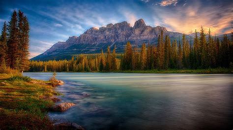 Landscape View Of Mountain Under Blue Sky And River Surrounded By Green