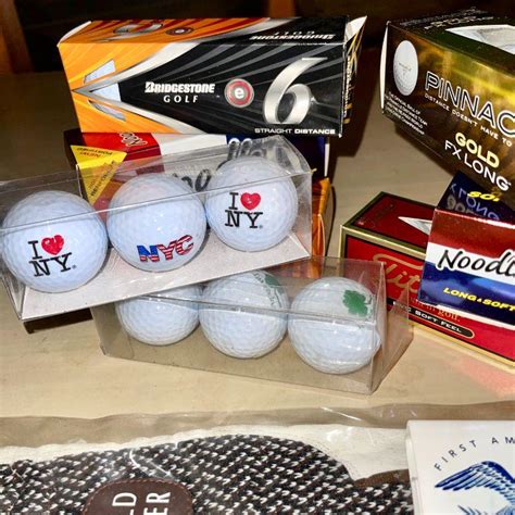 Lot 211 Group Of Packaged And Souvenir Golf Balls Glove Tees