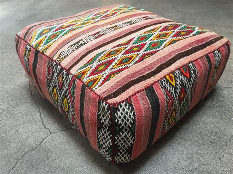 Go big and aim for lots of pillows, preferably in a larger size. Moroccan Floor Pillow Seat Cushion Made from a Vintage Tribal Berber Rug For Sale at 1stdibs