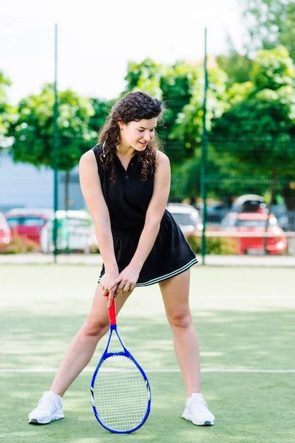 Young Woman Playing Tennis On Court Free Photo